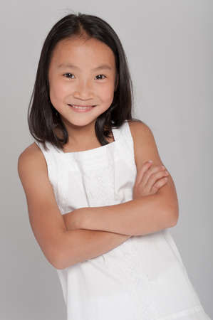 Portrait of a cute little girl of Asian backgroundの写真素材