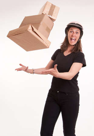 
Stressed woman with helmet trying to catch flying parcels
の写真素材