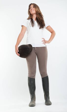 Young woman dressed in horse riding clothesの写真素材