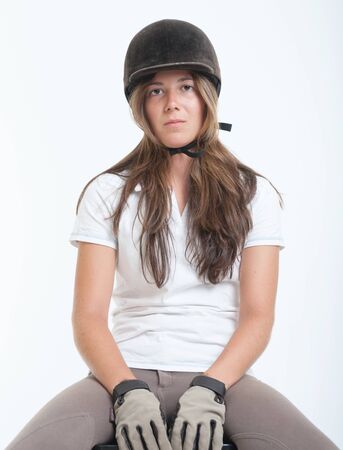 Young woman dressed in horse riding clothesの写真素材