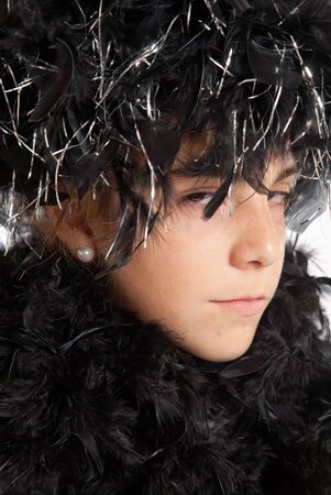 Young girl costumed with a feather boaの写真素材