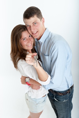 Young couple holding a bunch of keysの写真素材
