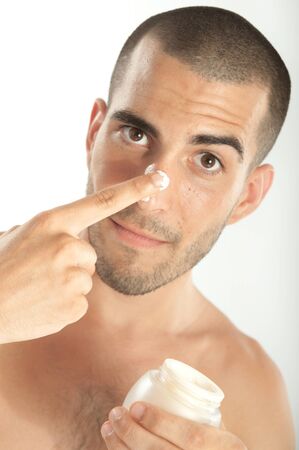 Attractive man  applying moisturizerの写真素材