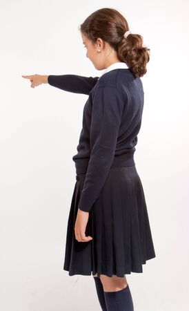 
Profile view of  a schoolgirl pointing at something, isolated in white
の写真素材