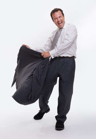 Laughing man in business attire bullfighting with his vestの写真素材