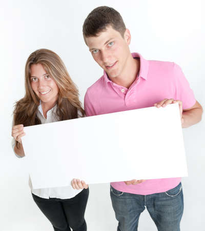 Young couple holding a blank board, ideal for inserting your own messageの写真素材