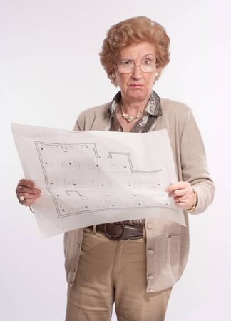 
Portrait of a displeased senior lady holding architecture blueprints
の写真素材