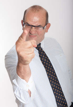 Man in business attire with threatening gestureの写真素材