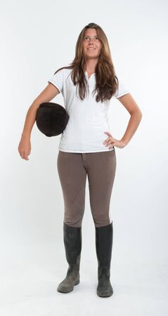 Young woman dressed in horse riding clothesの写真素材