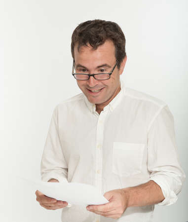 Man reading a document with a happy expressionの写真素材
