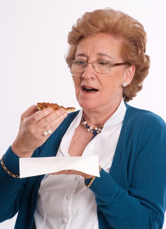 
Senior lady about to eat a pizza part
の写真素材