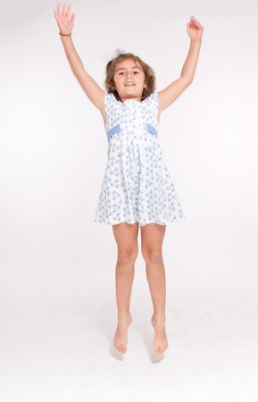 Little barefoot girl jumpingの写真素材