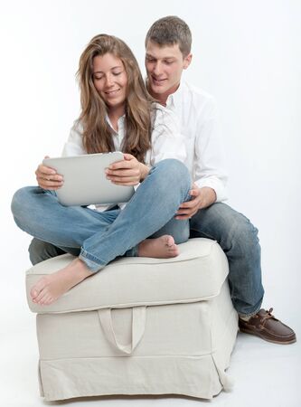 Young couple using a digital tabletの写真素材