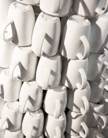 Huge pyramid of coffee cups in a café shopの写真素材