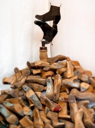 Composition of a pile of shoe. And a pair of boots on topの写真素材