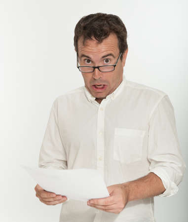 Man reading a document with an scared expressionの写真素材