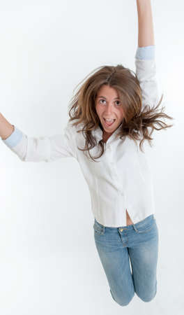 Young woman jumping with a happy expressionの写真素材