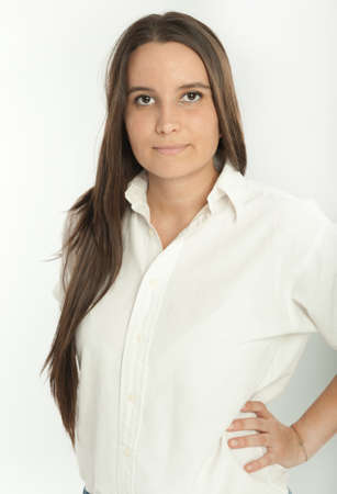 Serious long haired brunette in a white shirtの写真素材