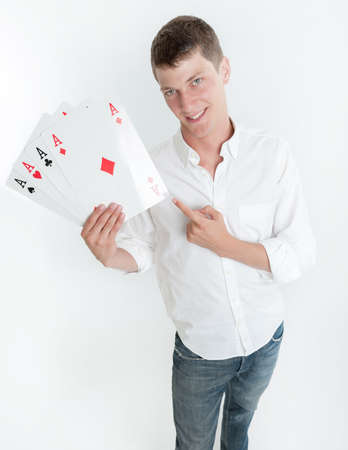 Young man holding four acesの写真素材