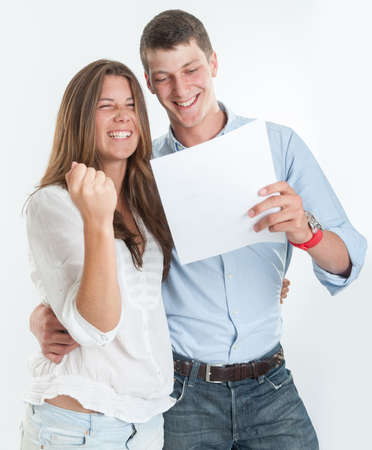 Young couple celebrating holding a documentの写真素材