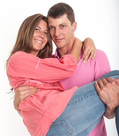 Young man carrying his girlfriendの写真素材