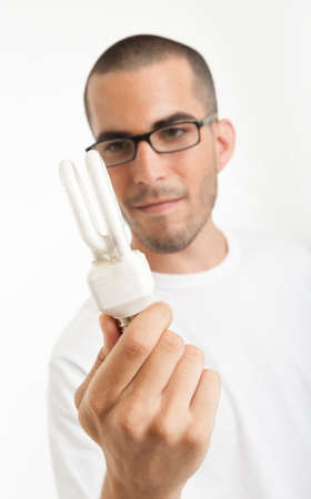 Man observing a energy efficient light bulbの写真素材
