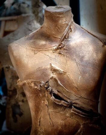 Old vintage mannequin painted in gold and slashedの写真素材