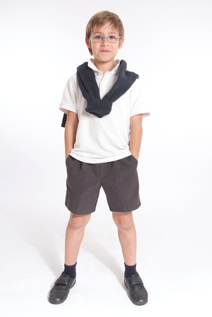Schoolboy standing with his hands in his pocketsの写真素材