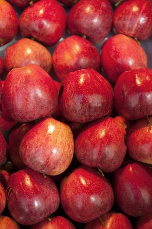 Red apples on a market stall, ideal for backgroundsの写真素材