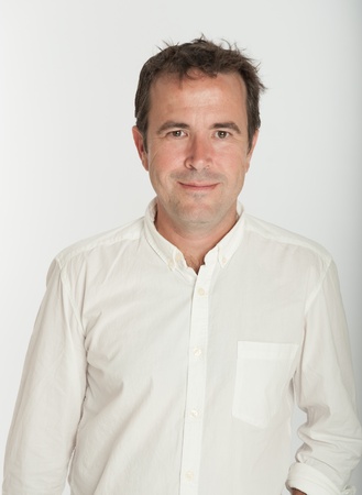 Smiling Male portrait with white shirt on a neutral backgroundの写真素材