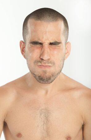 Expressive young man holding his breathの写真素材