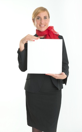 Smiling hostess holding a blank board ideal for inserting your own messageの写真素材