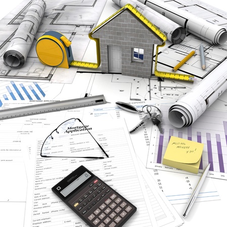 A house under construction on top of a table with mortgage application form, calculator, blueprints, etc.. の写真素材
