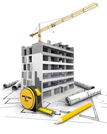 An apartment block in construction with a crane, on top of blueprintsの写真素材