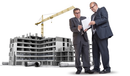 Two men in a dubious business deal by a building under constructionの写真素材
