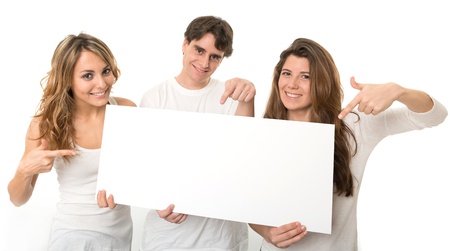 Three young people holding a blank sign, ideal for inserting your own messageの写真素材