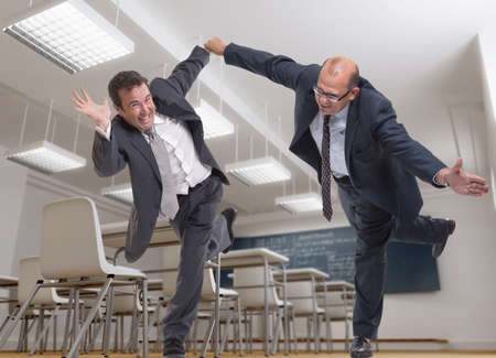 Two crazy men in business suits in a classroom