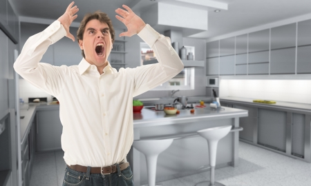 Angry man in a kitchenの写真素材