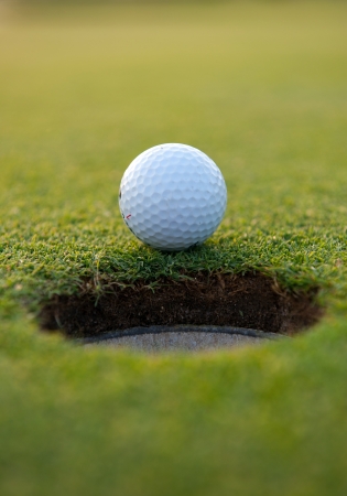 Golf ball close the cupの写真素材