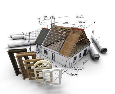 A house under construction, with blueprints and a selection of windows and doorsの写真素材