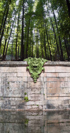 Fountain outlet with a devilish faceの写真素材