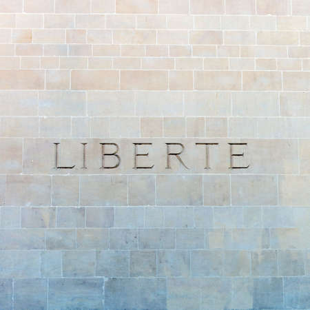 Liberté, the French word for freedom, carved on a wallの写真素材