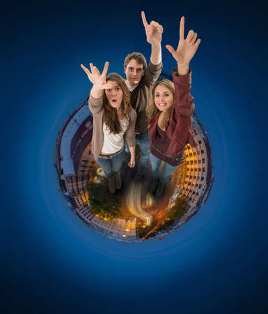 Three young people raising their hands above a circular cityscapeの写真素材