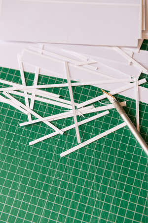 Scalpel and cutting mat and scraps of paperの写真素材