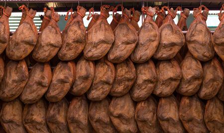 Spanish hams hanging in the marketの写真素材