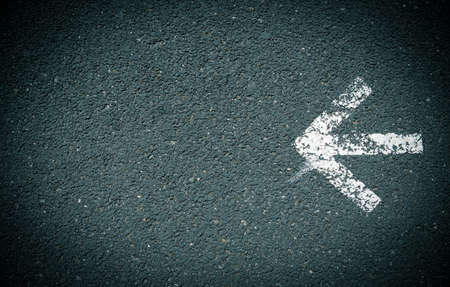White arrow painted on the roadの写真素材