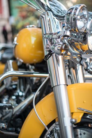 Partial view of a yellow retro motorbikeの写真素材