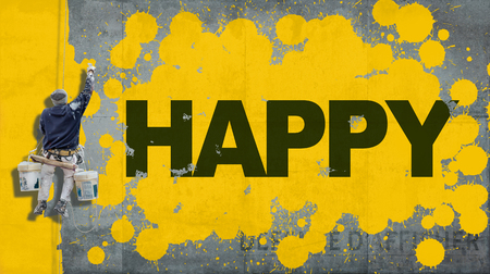 Painter hanging from harness painting a wall with the word Happyの写真素材