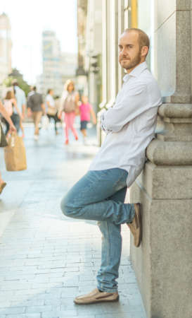 Young man leaning on a wall in downtown Madridの写真素材
