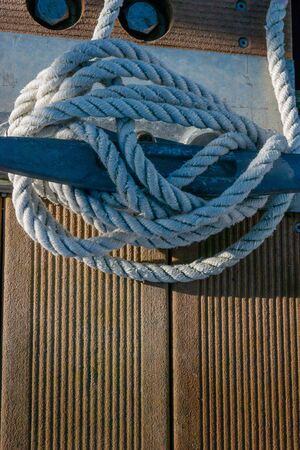 Mooring cleat with cord  on a wooden pier with lots of copy spaceの写真素材